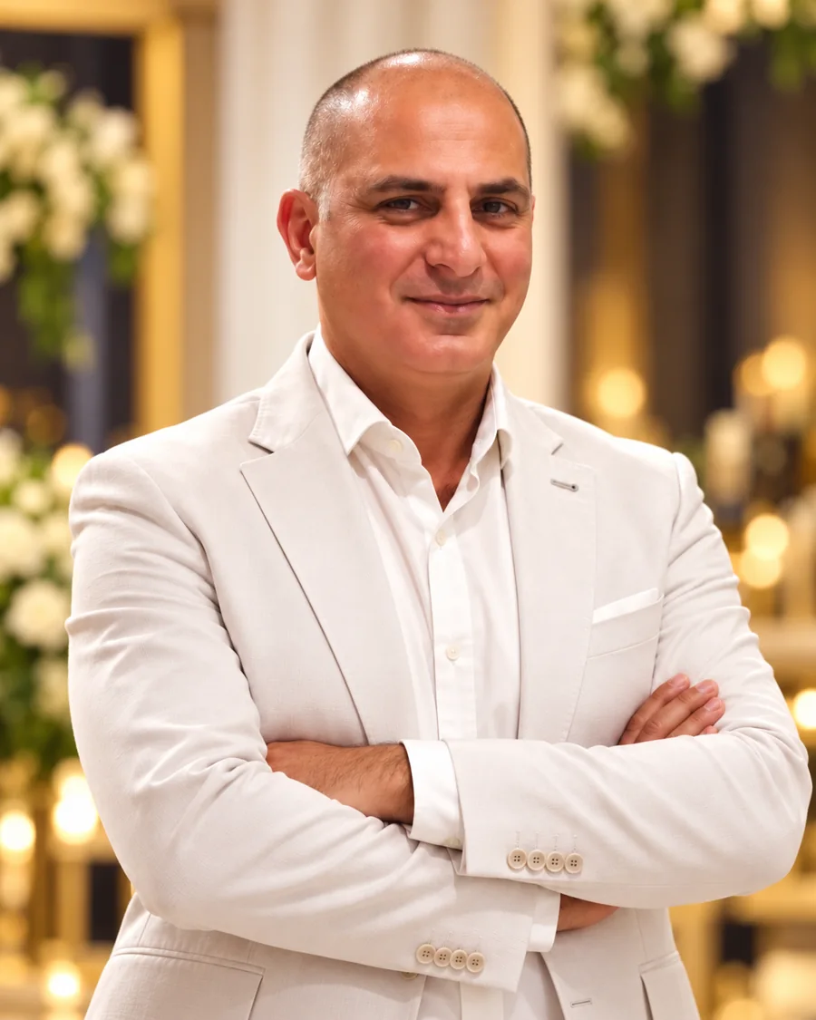 Luigi Barbaro, international hospitality executive, professional portrait in a light suit